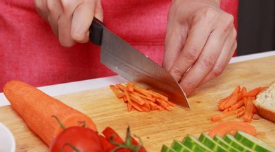 Easy Meal Prep Tips to Save Time in the Kitchen - Whole Family Living. Person's hands cutting up vegetables on cutting board.