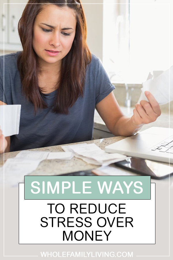 Simple Ways to Reduce Stress Over Money. Woman sitting at table with computer looking at bills.