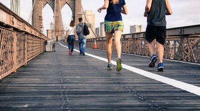 8 Healthy Habits to Start Your Day Off Right - man and woman jogging over a bridge